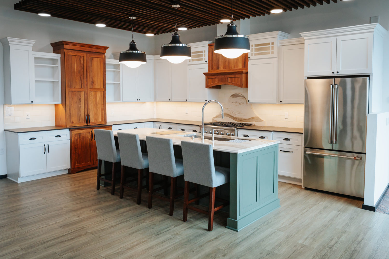 Multiple cabinet tones adds dimension to the kitchen.